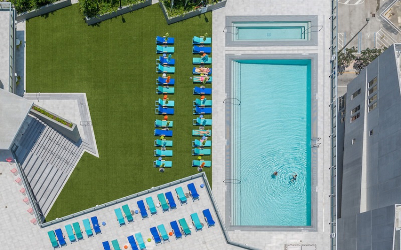 Aerial view of the pool and deck with rows of lounge chairs